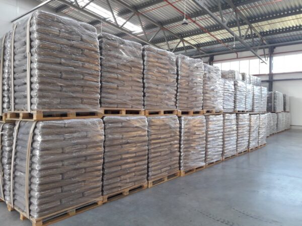 Hardwood heating pellets loaded on pallets for bulk trailer delivery and large-scale heating use